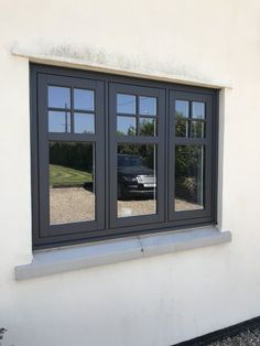 a car is seen through the windows of a house