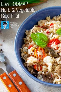 a blue bowl filled with rice and vegetables