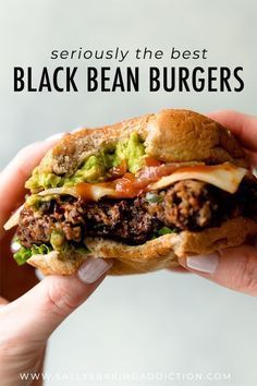 a hand holding a sandwich with meat, lettuce and tomato on it in front of the camera text reads seriously the best black bean burgers