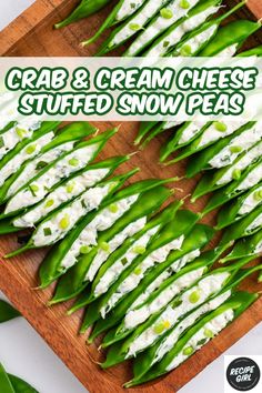 crab and cream cheese stuffed snow peas on a cutting board with text overlay that reads crab and cream cheese stuffed snow peas