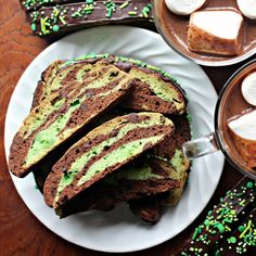 two plates with slices of cake and marshmallows on them