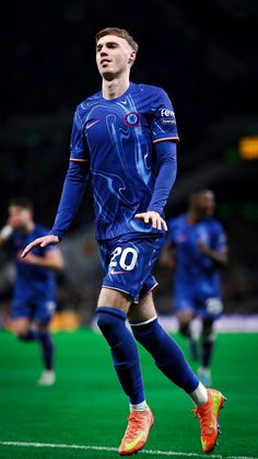 a soccer player is running on the field with his foot in the air as he prepares to kick the ball