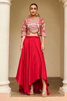 Carmine red top with all over floral embroidery using zardozi, aari work, french knots, and dori work. Paired with an asymmetric skirt. - Aza Fashions Red Skirt Outfits, Embroidery Zardozi, Dori Work, Top With Skirt, Asymmetric Skirt, Flattering Dress, Red Skirt, French Knots, Aari Work