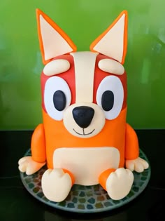 a cake shaped like a fox sitting on top of a plate