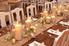 the table is set with candles and place settings