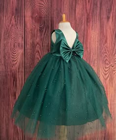 Our enchanting Ankle Length flower girl dresses are sure to turn heads! Bodice is made of Hunter Green satin, waist consists of a matching sowed in sash (NOT DETACHABLE) The back of the dress has an open deep V-Back with a hidden zipper, followed by a detachable bow. The skirt has 4 tulle layers for fullness, the top layer of tulle consists of pearls. The dress has 2 layers of lining with crinoline. This dress is perfect for any occasion!  Dress Is Pictured with a petticoat NOT INCLUDED https://www.etsy.com/listing/1305138635/white-ankle-length-petticoat-wedding?click_key=50d449c187c9e82c565249da914d7ed38b32b9f7%3A1305138635&click_sum=17db9314&ref=shop_home_active_2 Visit our store, more items to come!  https://www.etsy.com/shop/LittledarlnBoutique?ref=profile_header CUSTOM MEASUREMENTS AV Green Flower Girl Dresses, Baby Dress Embroidery, Frocks For Babies, Dark Green Dress, Flower Girl Dresses Tutu, Princess Ball Gowns, Flower Girl Tutu, Long Frocks, Etsy Wedding Dress