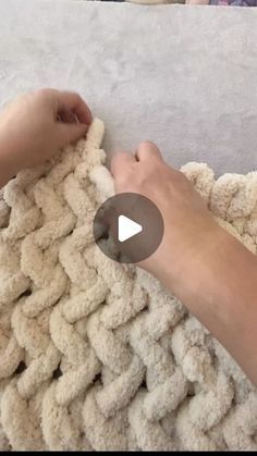 someone is crocheting a blanket with their hands