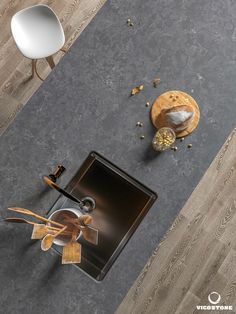 an overhead view of a kitchen with wood flooring and gray countertops, including a sink