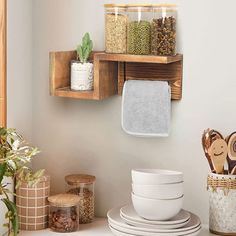 the kitchen is clean and ready to be used for cooking or baking, with dishes stacked on wooden shelves