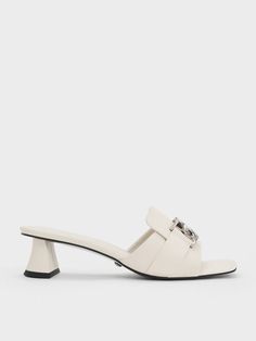 Step away from the ordinary black shoes and step into a world of elegance with these stunning chalk-white Gabine leather heeled mules. They offer the same incredible versatility and will effortlessly complement every piece in your wardrobe. The silver-toned interlocking Gabine buckles add a touch of understated sophistication to the design, elevating these mules to a whole new level of chic. From day to night, these block heel mules will keep you comfortable and fashionable, making them the ideal choice for any event or outing. Block Heel Mules, Online Shopping Shoes, Heel Mules, Size Chart For Kids, Chalk White, Charles Keith, Belt Size, Shoe Shop, Leather Heels