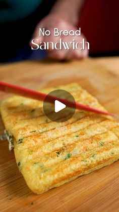 an omelet is sitting on a cutting board with chopsticks in it