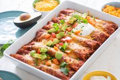 a white casserole dish filled with mexican food