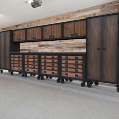 an empty room with wooden cabinets on wheels