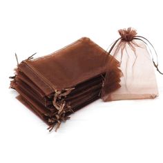 a stack of brown bags sitting next to each other on top of a white surface