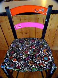 a colorful chair sitting on top of a wooden floor