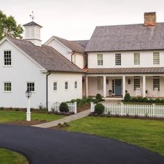 a large white house with a black driveway