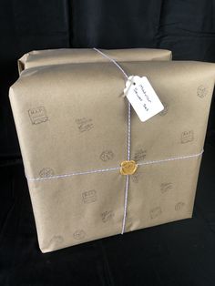 a brown wrapped present with a tag on it