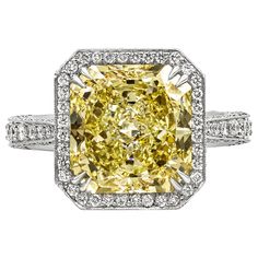 A vintage-looking engagement ring style showcasing a 5.27 carat radiant cut yellow diamond, certified by GIA as Fancy Light Yellow color, VS1 clarity. Surrounding the center diamond is a brilliant diamond halo in a diamond encrusted shank. Accent diamonds weigh 0.65 carats total. Finished with milgrain edges for that antique look and feel. Made in platinum. Size 6 Style available in different price ranges. Prices are based on your selection. Please contact us for more information. Canary Yellow Diamonds, Yellow Diamonds Engagement, Cushion Diamond Ring, Canary Diamond, Cushion Cut Diamond Ring, Vintage Style Engagement Rings, Engagement Rings Vintage Halo, Yellow Diamond Rings, Platinum Diamond Engagement Rings