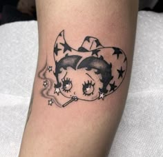 a tattoo on the arm of a woman with stars and a heart in the shape of a cat