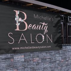 a sign for a beauty salon on the side of a building