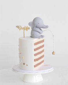 an elephant is sitting on top of a cake