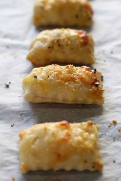 several pieces of food sitting on top of wax paper