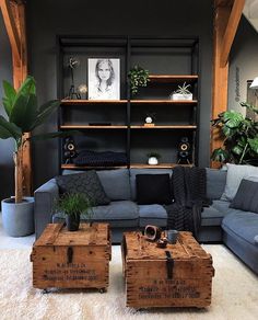 a living room filled with furniture and lots of wood boxes on top of it's coffee table