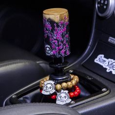 the interior of a car with skulls and flowers on it's steering wheel knob