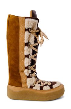 Shearling accents amplify the wintry vibes of a comfortable boot that's sure to be a street-style star. 1" heel 16" shaft; 13" calf circumference. Narrow calf Lace-up style Leather and genuine shearling (India) upper/leather lining/rubber sole Imported Luxury Winter Boots With Lug Sole, Luxury Brown Shearling Boots, Brown Sheepskin Boots With Faux Fur Lining, Winter Boots With Suede Lining And Shearling Material, Luxury Winter Boots With Faux Fur Trim, Winter Shearling Boots With Lug Sole, Luxury Mid-calf Boots With Round Toe For Winter, Mukluk Boots, Flat Platform Sandals