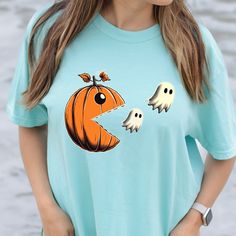 Comfort Colors® Pacman Pumpkin Shirt, Pumpkin Ghost T-Shirt, Cute Halloween Shirt, Funny Halloween Shirt, Pumpkin Shirt, Ghosts Pac-Man Tee 🌟🛍️ Welcome to the enchanting realm of NFS Apparel Co, where your shopping dreams become a magical reality! Prepare to be dazzled by our meticulously curated selection, crafted with love and care to provide you with an extraordinary shopping experience that will leave you radiating with joy! 😄✨ 👕 Behold the wonders of the Comfort Colors Tee, a true maste Pac Man Ghost Tshirt, Pacman Pumpkin, Soothing Bath, Pumpkin Ghost, Pac Man, Pumpkin Shirt, Comfort Colors Tee, Funny Halloween, Halloween Funny