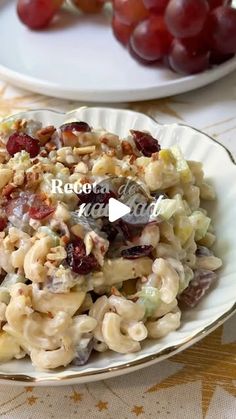 two plates with grapes and macaroni salad on them