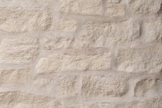 a white brick wall that has been made out of cement blocks and is very light brown