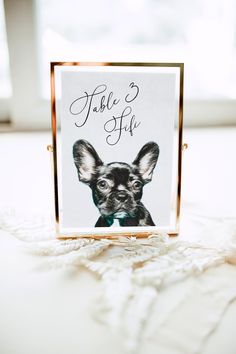 there is a small card with a dog's face on it and the words table 5 off