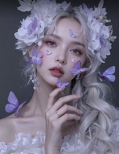 a woman with white hair and purple butterflies on her face is posing for the camera