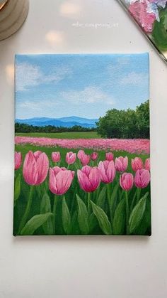 a painting of pink tulips on a white surface