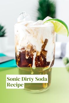 a glass filled with soda and topped with a slice of lime on top of it