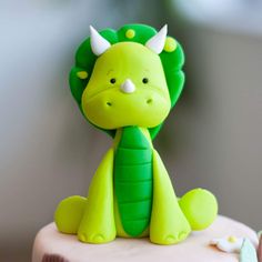 there is a cake with a green and white animal on it