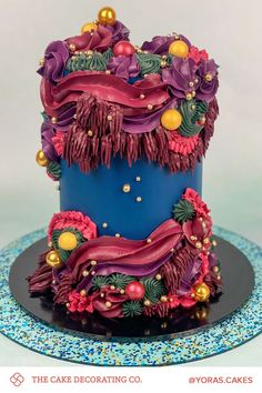 a blue cake with purple and red decorations