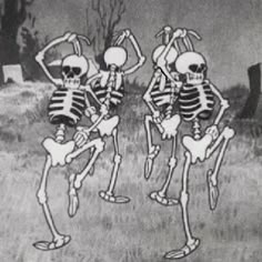 two skeletons dancing in front of a graveyard