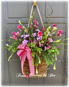 a basket filled with pink and purple flowers