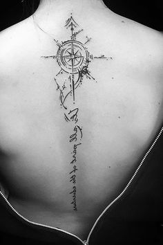 a woman with a compass tattoo on her back