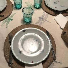 the table is set with plates and silverware