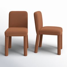 two brown chairs sitting side by side on a white surface with one chair facing the other