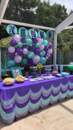 a purple and blue table topped with balloons