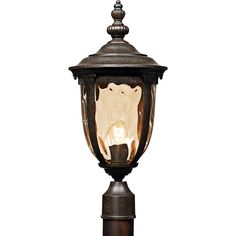 an old fashioned street light with a glass shade on it's top and base