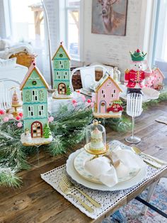 a wooden table topped with plates and dishes covered in christmas decorations on top of a wooden table