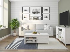 a living room with white furniture and pictures on the wall above the coffee table in front of the tv