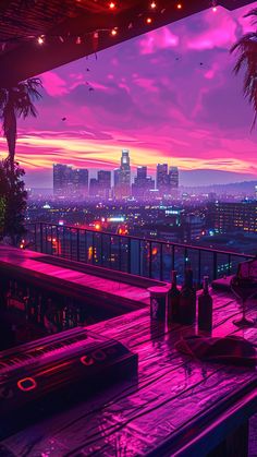 an outdoor bar overlooking the city at night with lights on and palm trees in the foreground