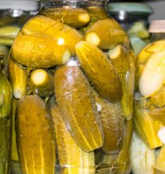 pickles in glass jars are sitting on the shelf next to each other and have been peeled