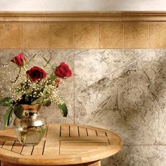 a vase with roses in it sitting on a wooden table next to a tiled wall